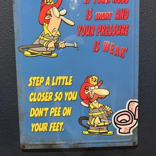 a sign with a fireman and a fire hydrant