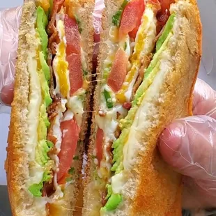 Super Duper Grilled Cheese &apos;Wich  Swiss, provolone, cheddar, cheese crispins, bacon, avocado, tomato, fried egg,w/green onion on Texas toast