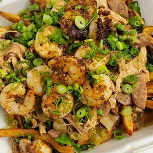Gumbo Fries with Blackened Shrimp  Hand-cut Cajun fries topped with chicken &amp; andouille gumbo with green onions and Blackened shrimp