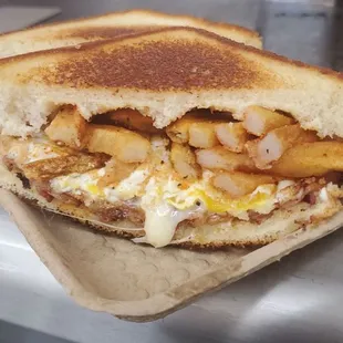 Breakfast &apos;Wich  Bacon, Swiss cheese, provolone cheese, fried egg, and hand-cut Cajun fries on Texas toast