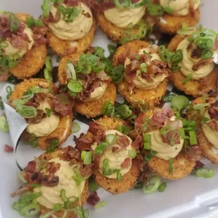 Deep Fried Cajun Devilled Eggs  Deep fried egg whites are filled with a creamy filling, topped with bacon and green onions