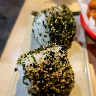 three sushi rolls on a plate