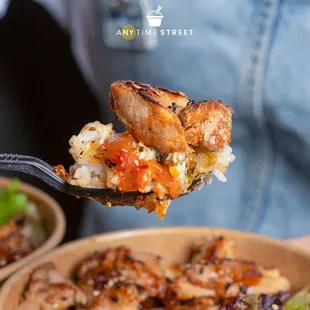 a person holding a spoon full of food