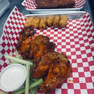 a plate of chicken wings with dipping sauce