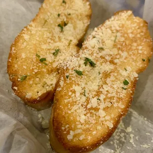 two pieces of bread with parmesan cheese