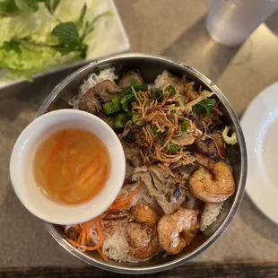 a bowl of food and a plate of salad