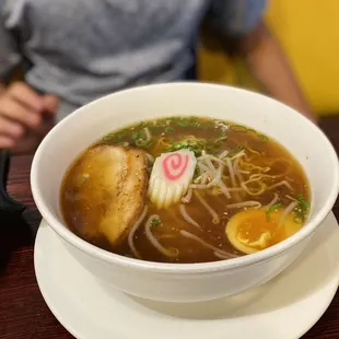 a bowl of soup with noodles and egg