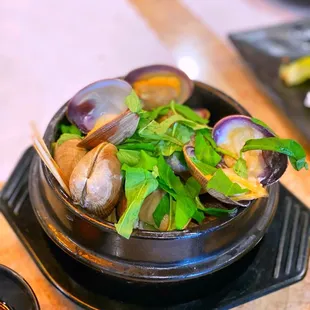 a bowl of clams on a table