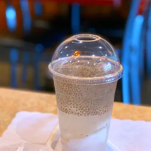 a plastic cup of coffee on a table