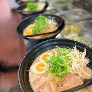 a row of bowls of ramen noodles