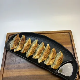 a plate of dumplings on a cutting board