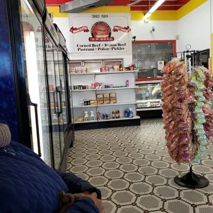 a man sitting on a bench in a deli