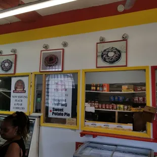 a woman standing in front of a deli counter