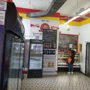 a woman standing in front of a refridgerator