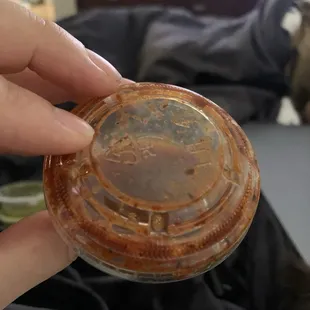 Spoiled red salsa- container blown up from gases formed from bacteria