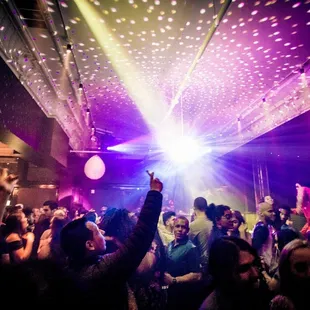 a crowd of people dancing at a party