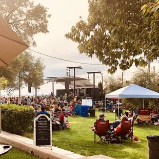 a crowd of people sitting under umbrellas