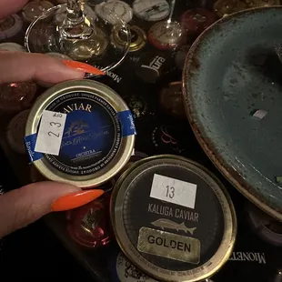 a person&apos;s hand reaching for a can of cavia