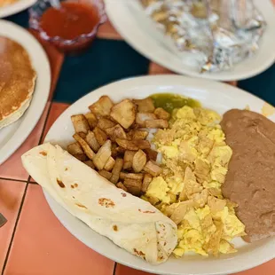 Off menu- Migas with a side of short stack pancakes and Barbacoa tacos