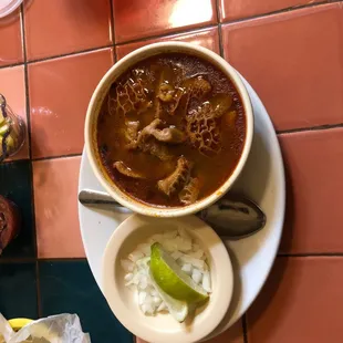 a bowl of soup and tortillas