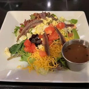 a plate of salad with dressing