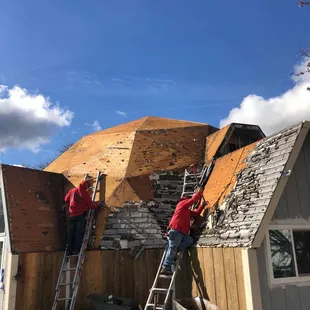 The crew removing the old existing roof.