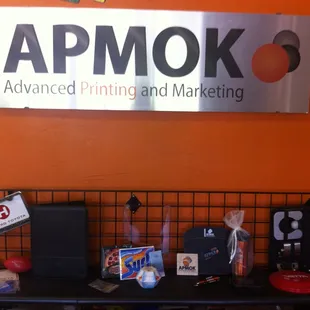 The sign was printed on die bond, and below it our some of our promotional items.