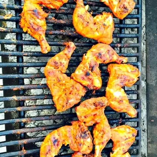 chicken wings cooking on a grill