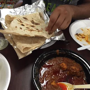 Digging into the soft, flakey, warm rumali roti