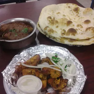 Goat curry in upper left and tandoori chicken wirh naan