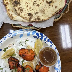 a plate of food and a bowl of sauce