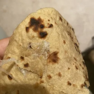 a person holding a burrito