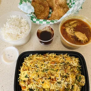 Vegetable biryani and curry chicken, samosas