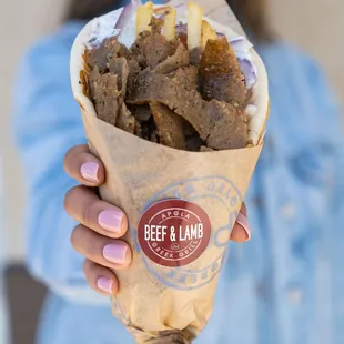 a woman holding a burrito