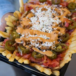 a person holding a tray of food