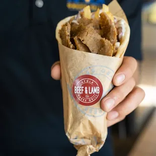 a person holding a burrito