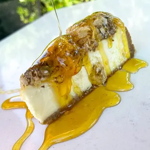 a piece of cheesecake with caramel sauce