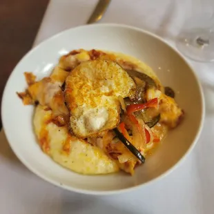 Enchiladas over grits sub sunny egg with hard fried yummy