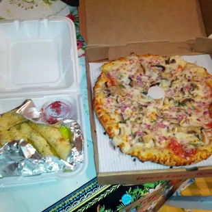 Three-topping carry out special and garlic breadsticks.