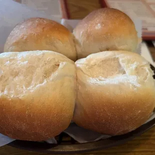 four rolls of bread on a plate
