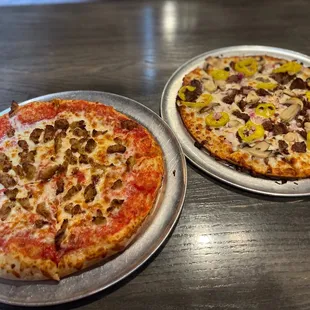 two pizzas on a table