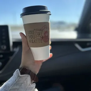 a hand holding a cup of coffee