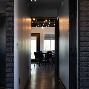 a long hallway with a table and chairs