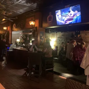 a bar with a large screen tv