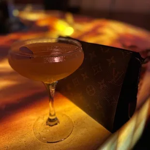 a glass of alcohol on a table