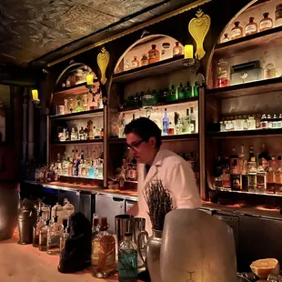 The mixologists dressed in pharmacist-style garb