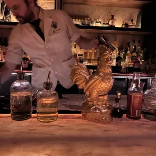 a bartender preparing a drink at a bar
