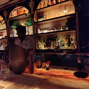 a bartender behind a bar counter