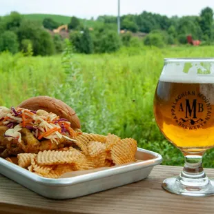 a plate of food and a glass of beer