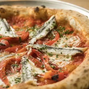 Boquerones Pizza: Tomato sauce, Mozzarella, roasted red bellpepper, white anchovy, and Italian Parsley.
